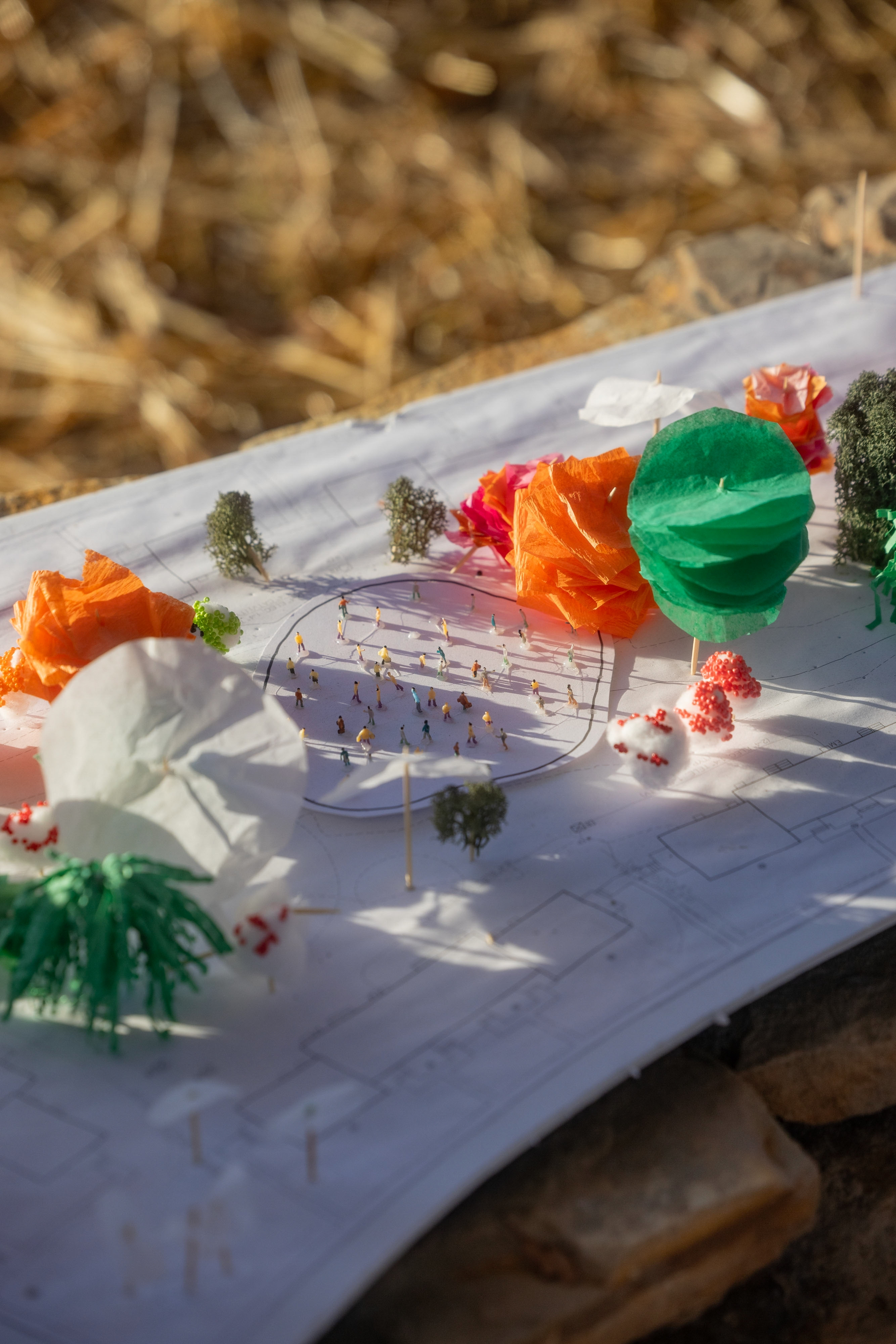 a close up of an artististic rendering of a park using colored papers.