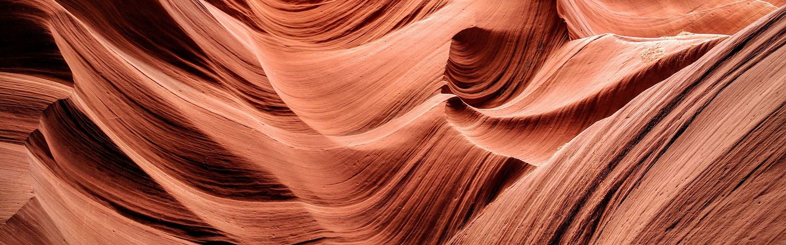 Abstract view of the red flowing rocks of a slot canyon.