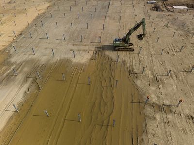 A large piece of construction equipment in an open field.